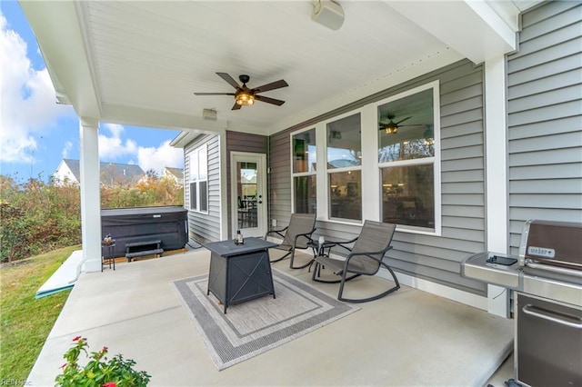 view of patio / terrace featuring a ceiling fan, a grill, and a hot tub