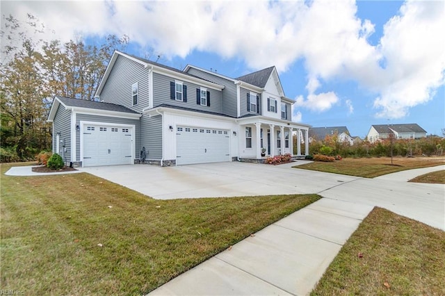 view of front of home with covered porch, concrete driveway, a front lawn, and an attached garage