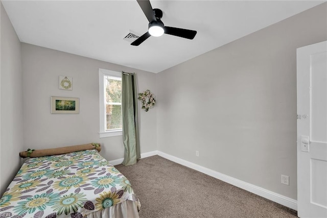 carpeted bedroom with a ceiling fan, visible vents, and baseboards