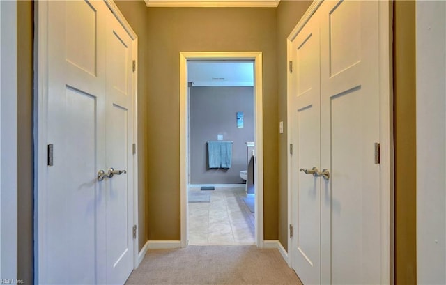 hall featuring light carpet and baseboards