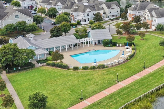 pool with a residential view, a yard, and a patio