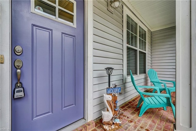 view of exterior entry with a porch