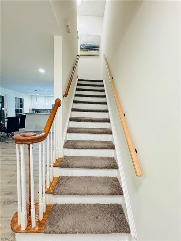 stairway featuring wood finished floors