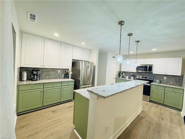 kitchen featuring light wood-style floors, visible vents, appliances with stainless steel finishes, and green cabinetry