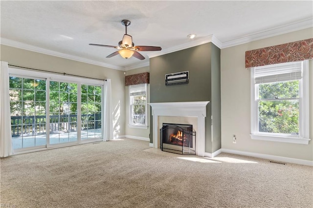 unfurnished living room with a fireplace with flush hearth, visible vents, carpet flooring, and ornamental molding