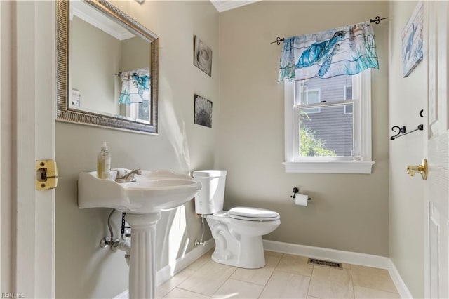 half bath with toilet, baseboards, visible vents, and tile patterned floors