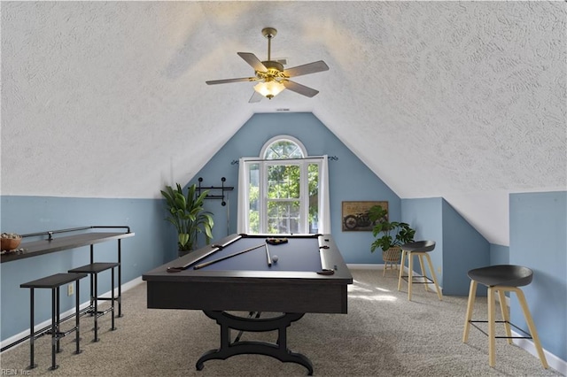 rec room with baseboards, pool table, vaulted ceiling, a textured ceiling, and carpet floors