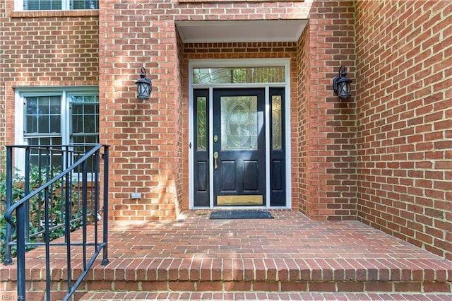 doorway to property with brick siding