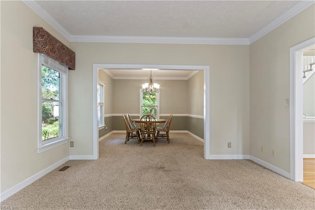 dining room featuring visible vents, an inviting chandelier, ornamental molding, carpet flooring, and baseboards