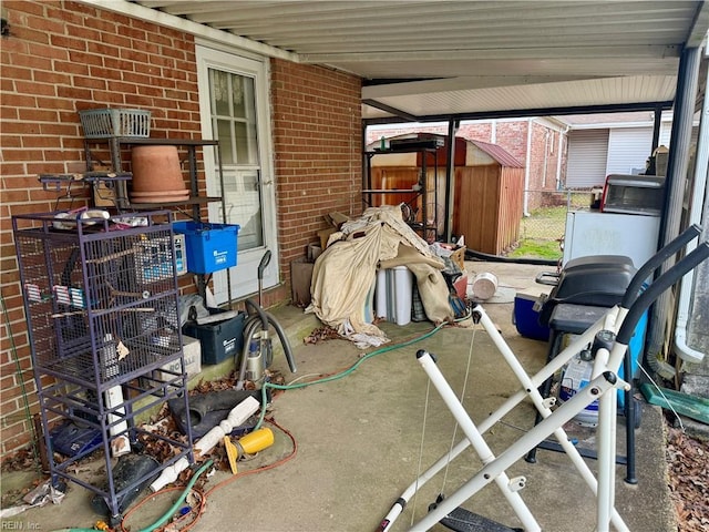 view of patio featuring a shed, fence, and an outbuilding