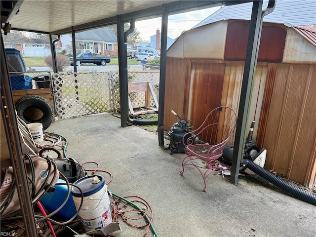 view of patio with a residential view and fence