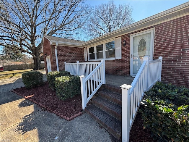 view of exterior entry with brick siding