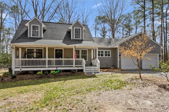 cape cod home featuring roof with shingles, covered porch, an attached garage, a front yard, and driveway