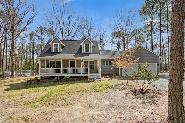 cape cod-style house with a garage, a porch, a front lawn, and fence