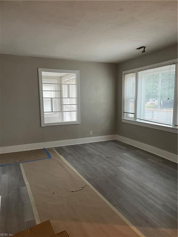 unfurnished room featuring wood finished floors and baseboards