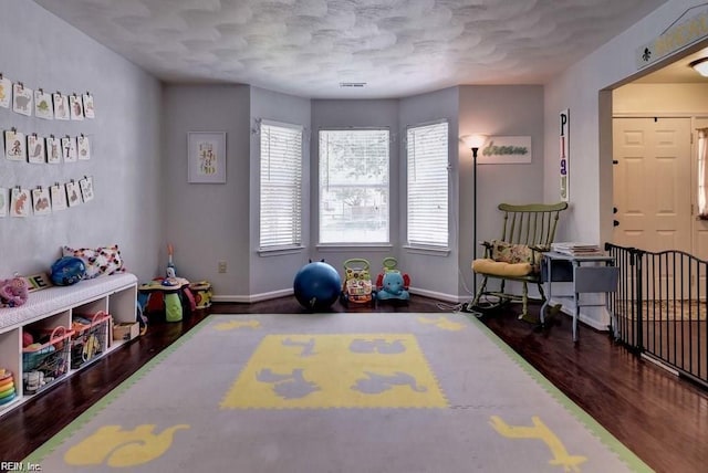 recreation room with wood finished floors and baseboards