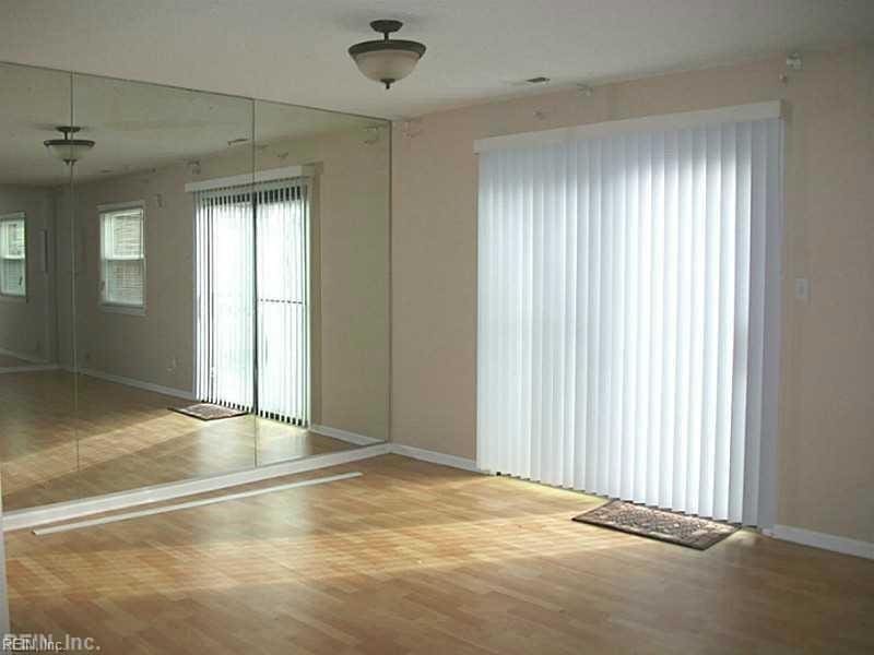 unfurnished room featuring wood finished floors and baseboards