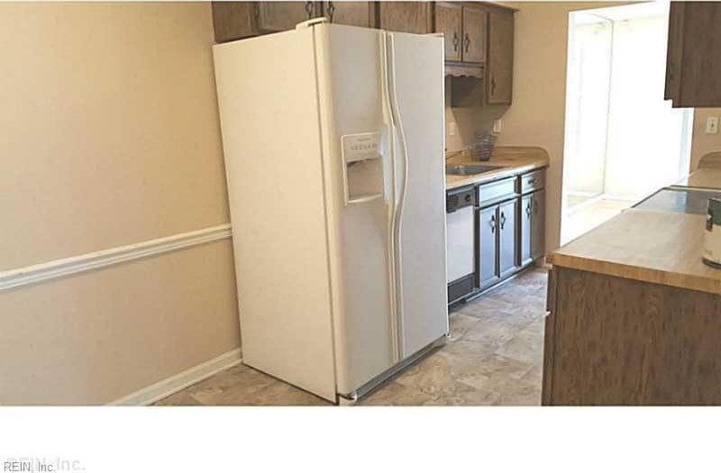 kitchen featuring dishwasher, white fridge with ice dispenser, light countertops, and baseboards