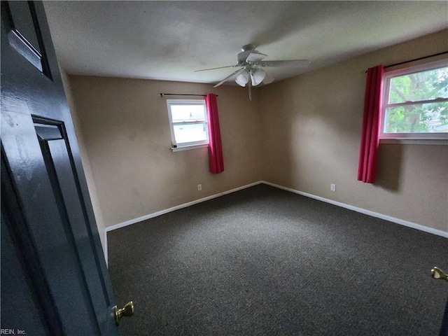 empty room with carpet floors, baseboards, and a ceiling fan