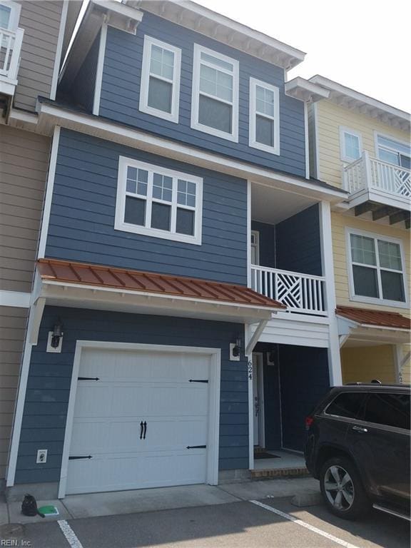 view of property featuring metal roof, a standing seam roof, and an attached garage