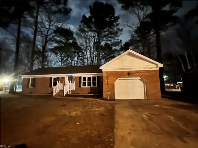 single story home featuring a garage and concrete driveway