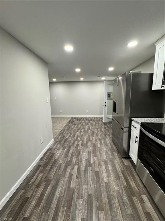 kitchen featuring white cabinets, stainless steel appliances, and dark wood finished floors