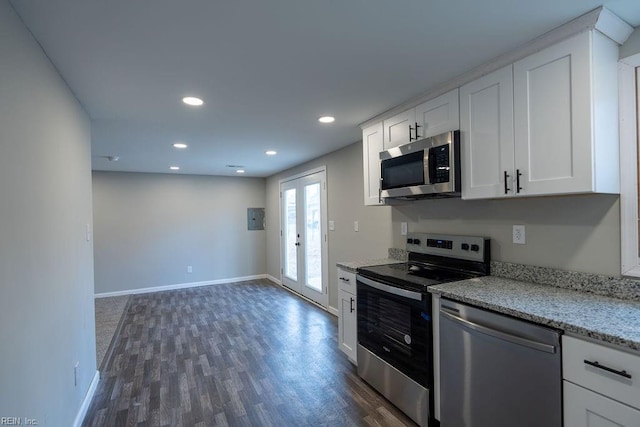 kitchen with white cabinets, dark wood-style floors, light stone countertops, stainless steel appliances, and french doors