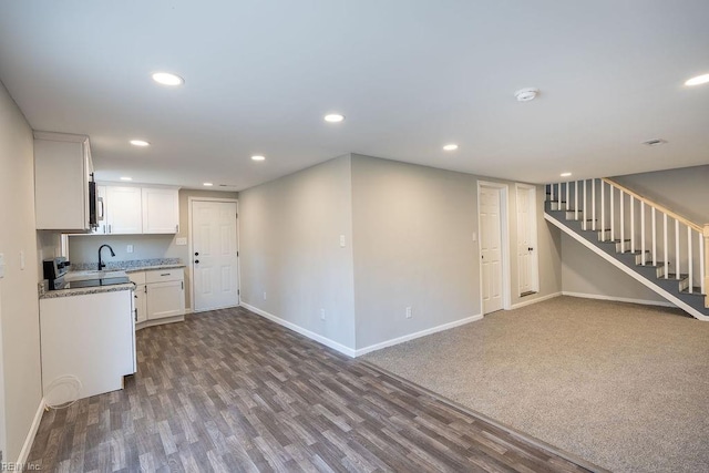 kitchen with baseboards, white cabinets, stainless steel microwave, dark wood-style flooring, and recessed lighting