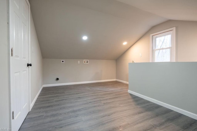 bonus room featuring lofted ceiling, baseboards, and wood finished floors