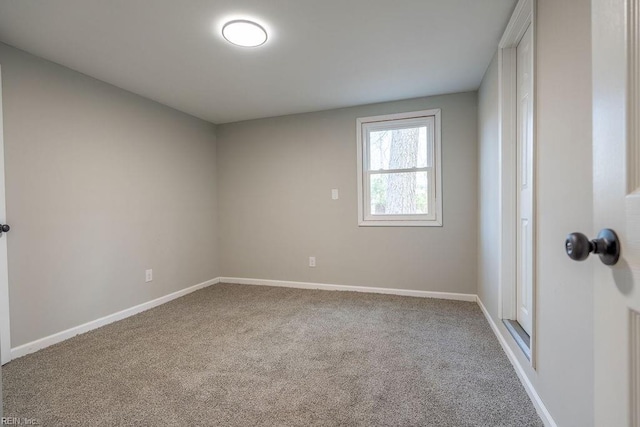 empty room with carpet flooring and baseboards