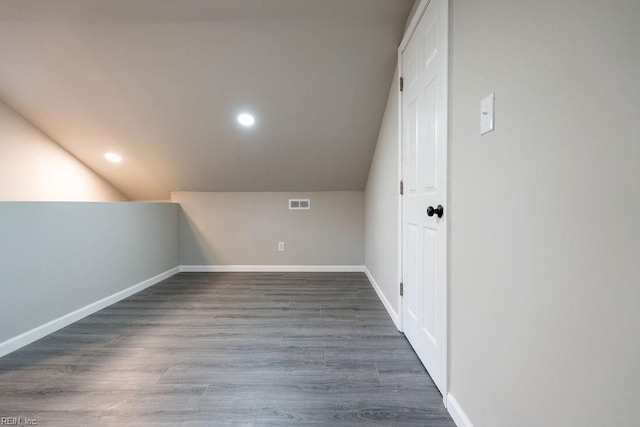 bonus room with baseboards, visible vents, lofted ceiling, dark wood-type flooring, and recessed lighting