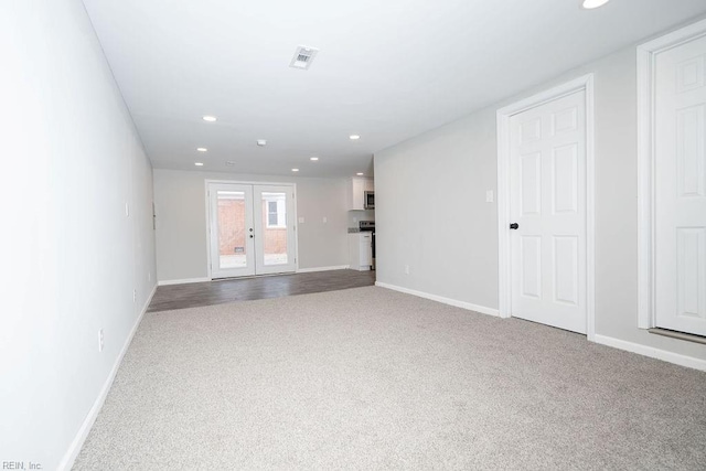 carpeted empty room featuring recessed lighting, french doors, visible vents, and baseboards