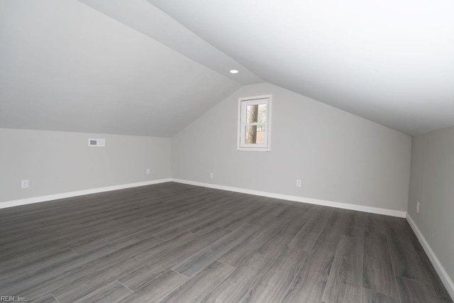 bonus room with visible vents, baseboards, lofted ceiling, dark wood-style flooring, and recessed lighting