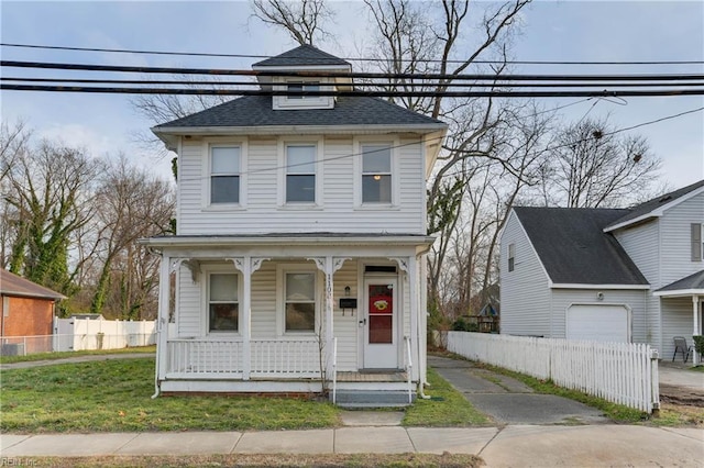 view of front of home with a porch, a front yard, and fence