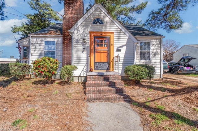 view of front of house featuring a chimney