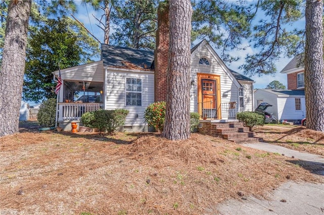 view of front of house featuring crawl space, covered porch, and a chimney