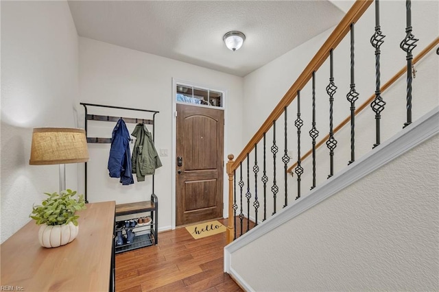 entryway featuring stairs and wood finished floors