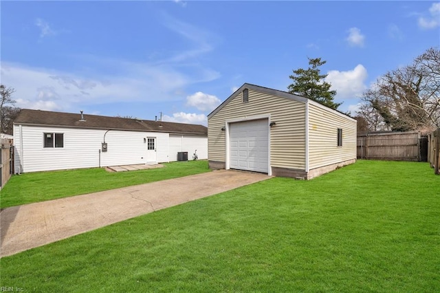 detached garage featuring driveway, central AC unit, and fence