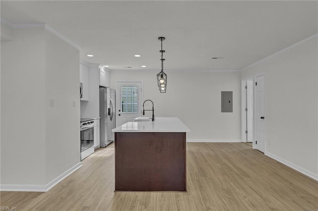 kitchen with ornamental molding, stainless steel appliances, light countertops, light wood-style floors, and a sink