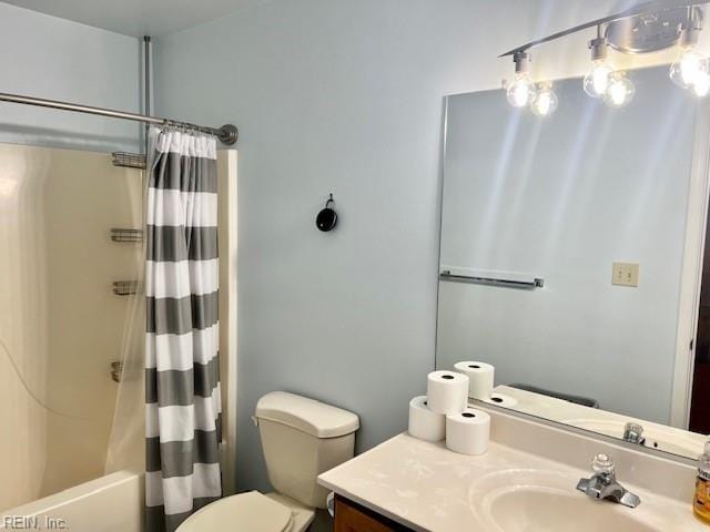 bathroom featuring shower / bath combo, vanity, and toilet