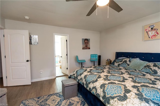 bedroom with ceiling fan, baseboards, and wood finished floors