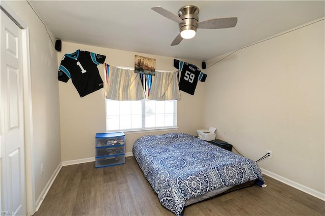 bedroom featuring ceiling fan, wood finished floors, and baseboards