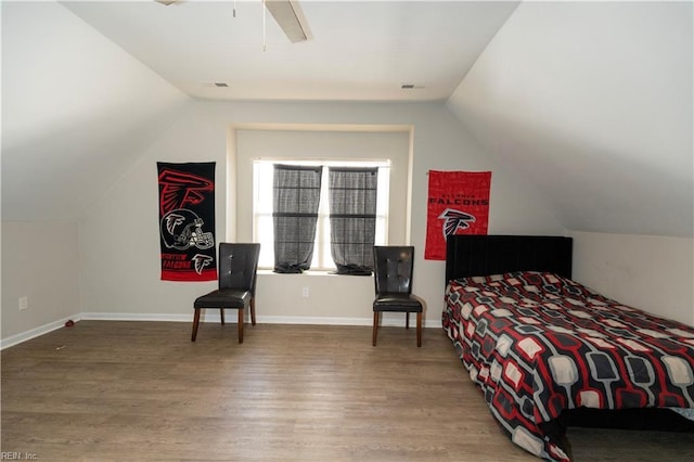 bedroom featuring visible vents, baseboards, a ceiling fan, lofted ceiling, and wood finished floors