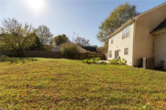 view of yard featuring cooling unit and fence