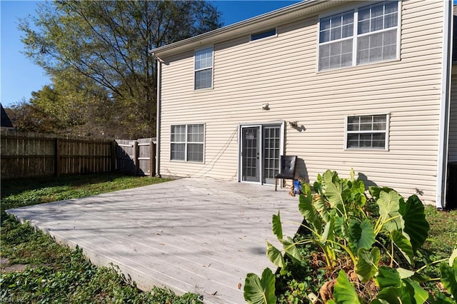 back of house featuring fence and a wooden deck