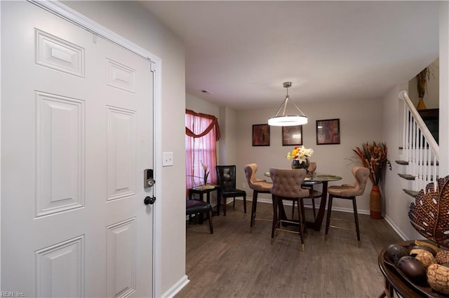 dining room with visible vents, stairs, baseboards, and wood finished floors