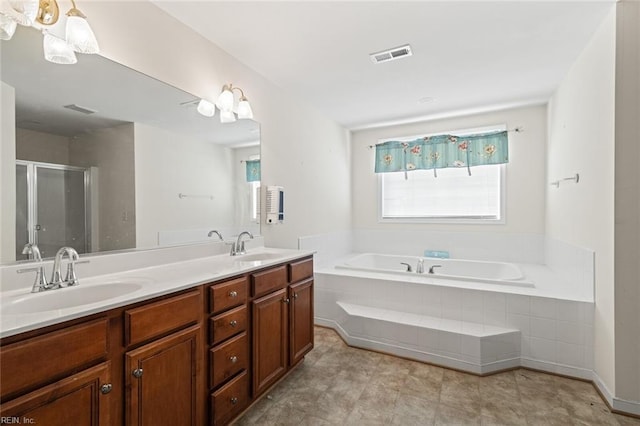 full bath featuring a bath, a sink, visible vents, and a shower stall