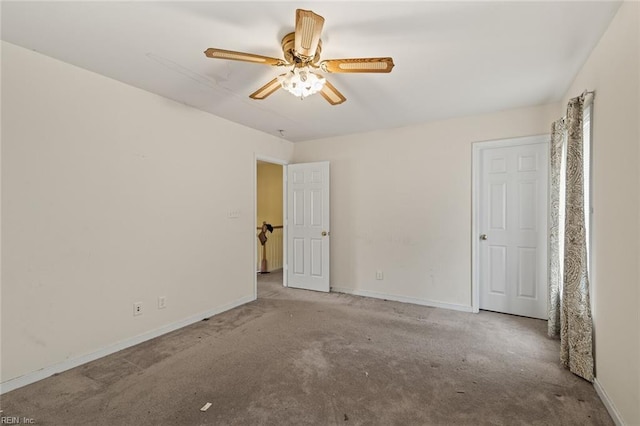 unfurnished bedroom featuring carpet, a ceiling fan, and baseboards