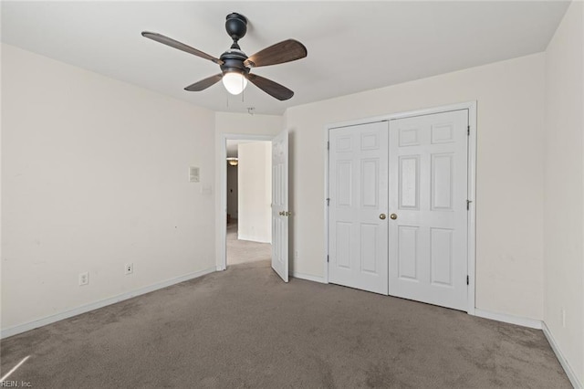 unfurnished bedroom featuring carpet floors, ceiling fan, baseboards, and a closet