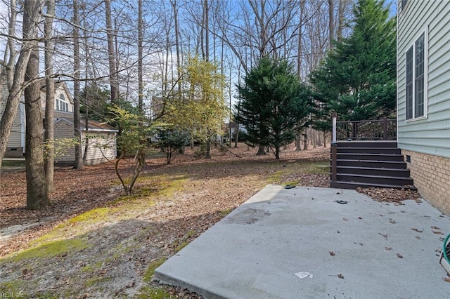 view of yard featuring stairs, a deck, and a patio area